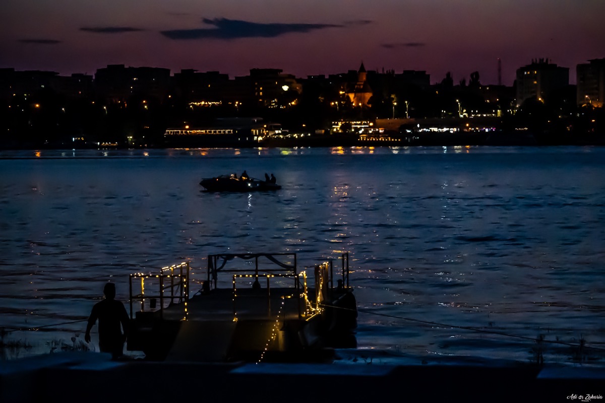 Illuminated boat on the Danube at sunset